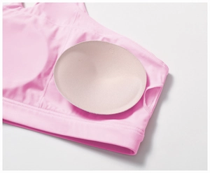 Detail view of pink yoga bra with removable round pads and breathable mesh lining