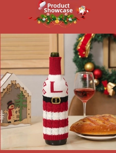 Close-up of a festive knitted Christmas wine bottle cover with red and white stripes and belt
