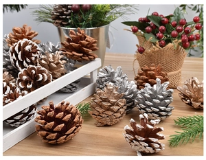 Close-up of assorted gold, silver, and natural pine cones in a wooden basket for Christmas