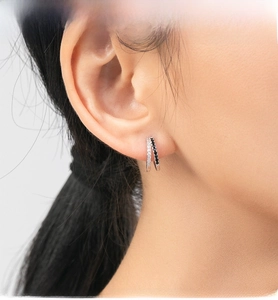 Detail of s925 silver double hoop earrings with black and white crystal inlay