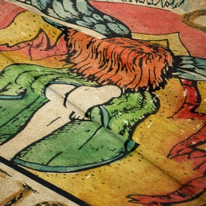 Macro shot of bohemian tapestry fabric showing vintage printed texture and textile weave
