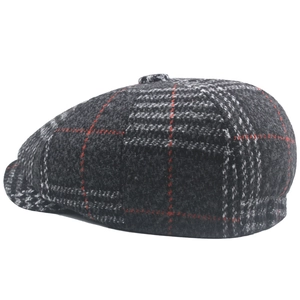 Detail of gray houndstooth wool flat cap with fine red lines and top decorative button