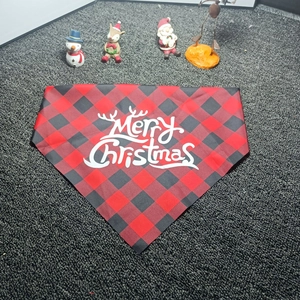 Close-up of red and black plaid Christmas pet bandana with Merry Christmas print