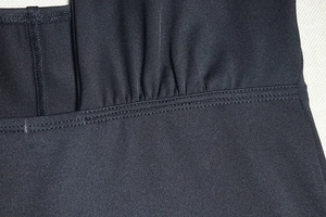 Close-up of black elastic knit fabric showing flat seam stitching and texture details