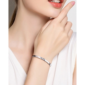 Close-up of minimalist S925 sterling silver flat snake bone chain bracelet on female wrist
