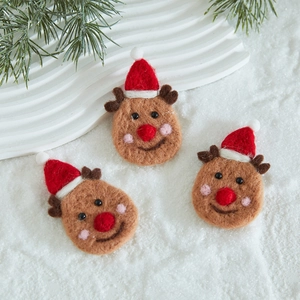 Handmade wool felt reindeer Christmas tree ornaments set on a snowy winter background