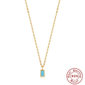 Macro detail of rectangle turquoise pendant on S925 sterling silver gold chain