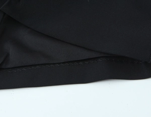 Macro detail of elastic black fabric showing premium stitching and textured inner seams