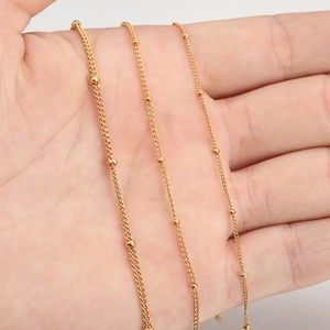 Three sizes of 18K gold plated stainless steel curb chains with beads held in hand