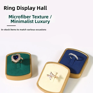 Macro shot of 4-slot ring display stands in premium microfiber with golden metal borders