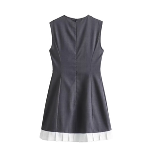 Back view of a sleeveless high-waist mini dress in dark grey with pleated white hem