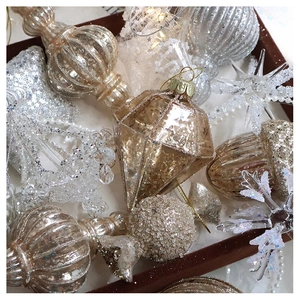 Detailed collection of champagne gold and white Christmas ornaments with glitter and beads