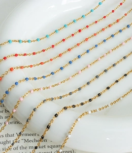 Detail of colorful enamel bead chain necklaces and bracelets in vibrant dopamine colors
