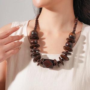 Detailed view of handmade dark brown wood bead statement necklace with geometric pendant