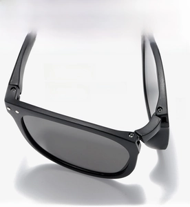 Detailed macro view of the sturdy multi-screw hinge on black foldable sunglasses