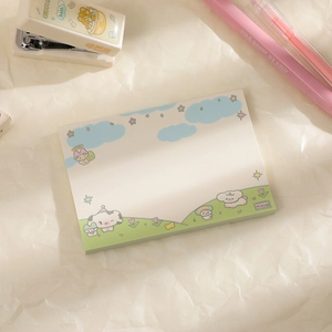 Flat lay of cute cartoon landscape sticky notes with a pink pen and stapler on paper