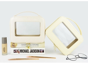 Detail of premium beige cosmetic bag with clear PVC window and gold zipper finish