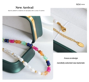 Detailed close-up of Baroque freshwater pearls and colored natural stones on necklace