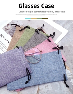 Detail view of colorful linen drawstring pouches with textured fabric and black cords