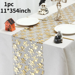 Detail view of 11x354 inch grey Halloween mesh table runner with gold skull print patterns