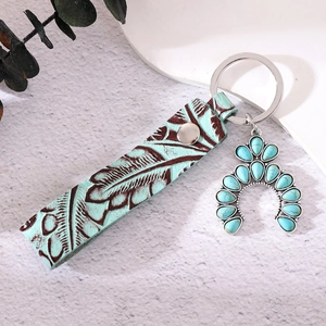 Brown leather keychain with southwest turquoise inlay and embossed feather pattern detail