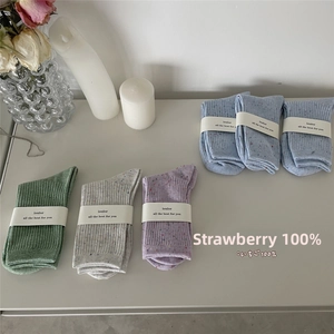 Detailed knit texture of colorful speckled cotton socks with ribbed cuffs on display