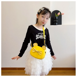 Detailed view of yellow mini cat-ear bag with sequin bow and shiny ears for girls