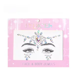 Close-up of iridescent face jewels set with rhinestones and white pearls for body art