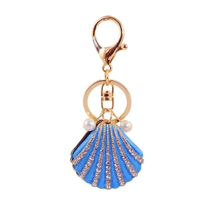 Blue rhinestone shell keychain with gold metal plating and decorative faux pearls