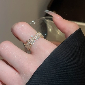 Close-up of 18k gold plated ring with cubic zirconia crown design on model hand