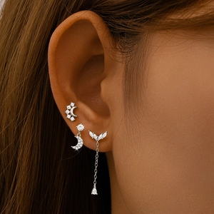 Close-up of S925 silver moon and star earrings with zircon inlay for cartilage piercing