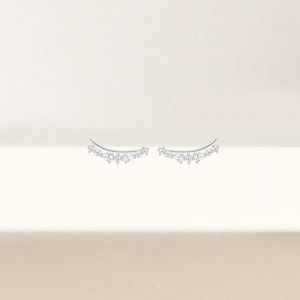 Detailed close-up of curved S925 silver ear crawlers featuring sparkling white zircon stones