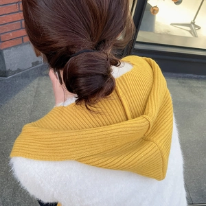 Detail view of ginger yellow ribbed knit hooded scarf showing thick soft winter texture