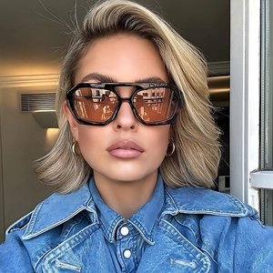 Classic aviator sunglasses with gradient brown lenses worn by model in natural light