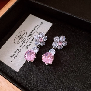Close-up of pink and white zircon flower earrings presented in a black jewelry gift box