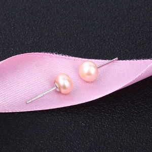 Macro shot of S925 sterling silver studs with round light pink freshwater pearls