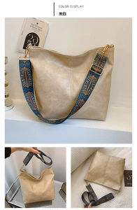Close-up of beige lychee grain leather tote bag with wide geometric pattern strap