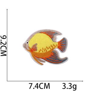 Fish embroidered patch with dimensions 9.2cm by 7.4cm in yellow and blue colors