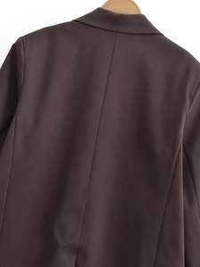 Detail of dark coffee double-breasted blazer back seam and premium woven texture