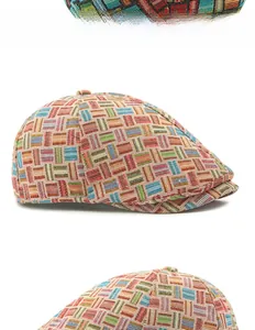 Close-up of colorful mosaic geometric patterns on a textured vintage newsboy cap