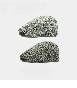 Close-up of jacquard beret hats featuring metal side buckles and retro textured fabric