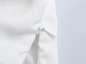 Detailed close-up of a white invisible zipper on the elegant floral fishtail skirt