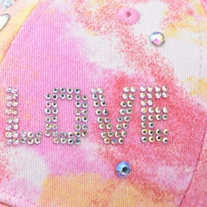 Tie-dye baseball cap with colorful rhinestones forming LOVE text on twill fabric