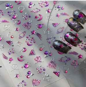 Detailed macro view of 3D embossed star and moon nail stickers with metallic purple finish