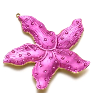 Macro shot of 60mm magenta flower pendant with textured petals and golden edges