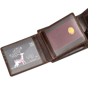 Close-up of genuine leather wallet showing card slots and orange contrast stitching