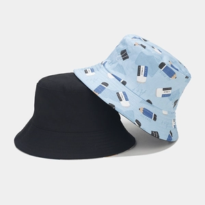 Close-up of cotton bucket hats featuring cute pencil stationery print and plain black side