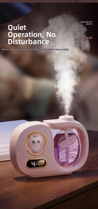 Pink cat humidifier detail showing the circular digital display and fine mist spraying