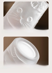 Macro view of 3D cat relief pattern and thick stable base on frosted glass tea cup