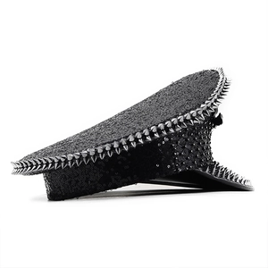 Detail of black sequined captain hat with silver punk metal spikes on pure background
